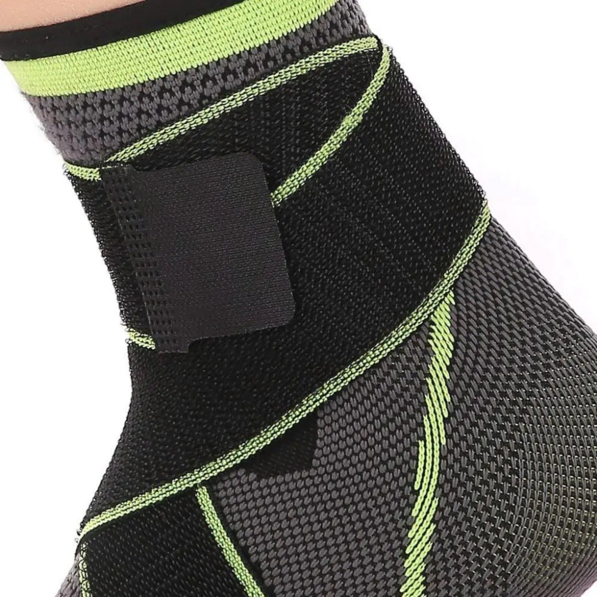 Black and green ankle support brace on a white background